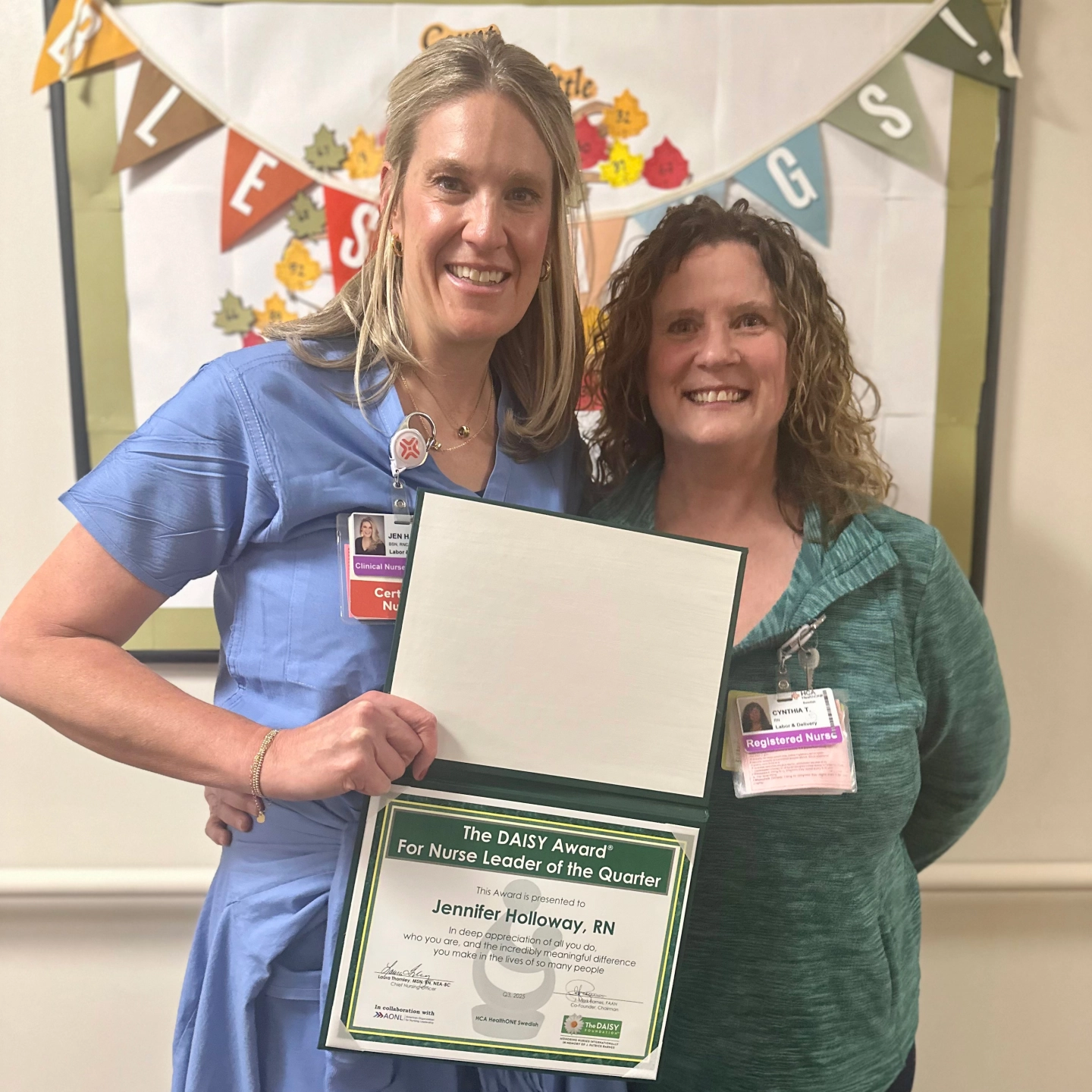 two ladies holding award