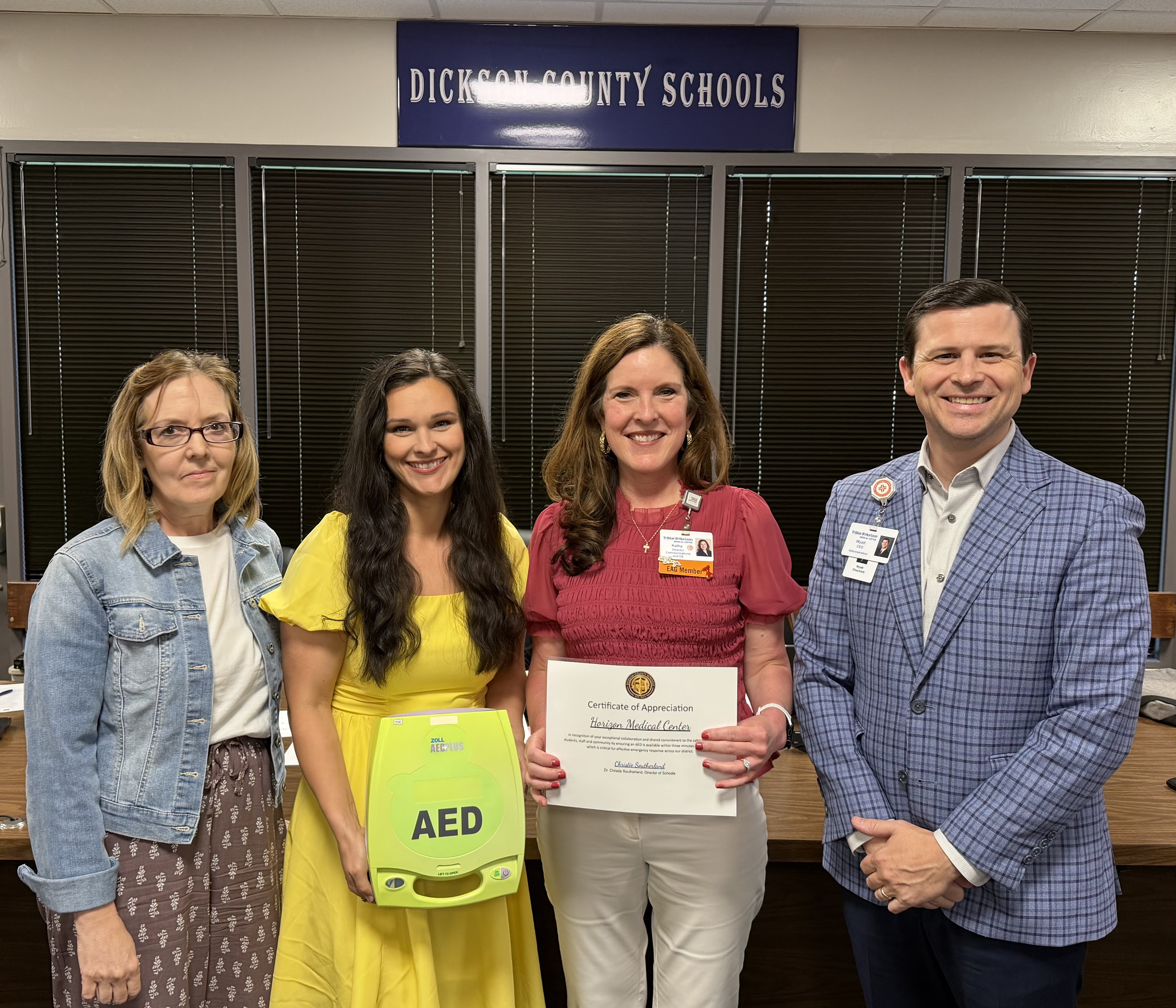 TriStar Horizon officials and Dickson County Schools officials pose for a photograph with an AED.