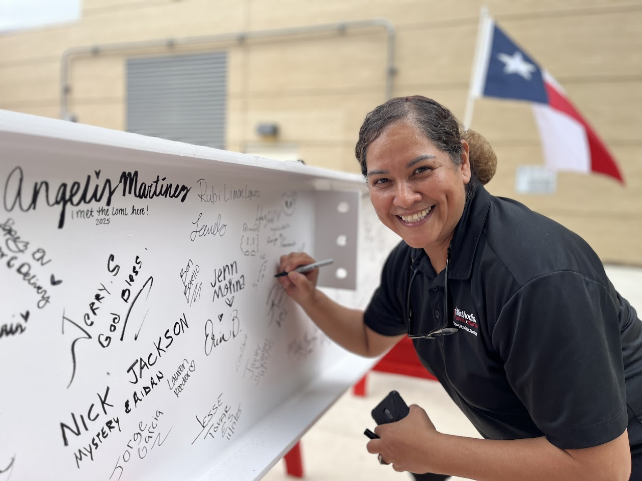 Employee signing the beam