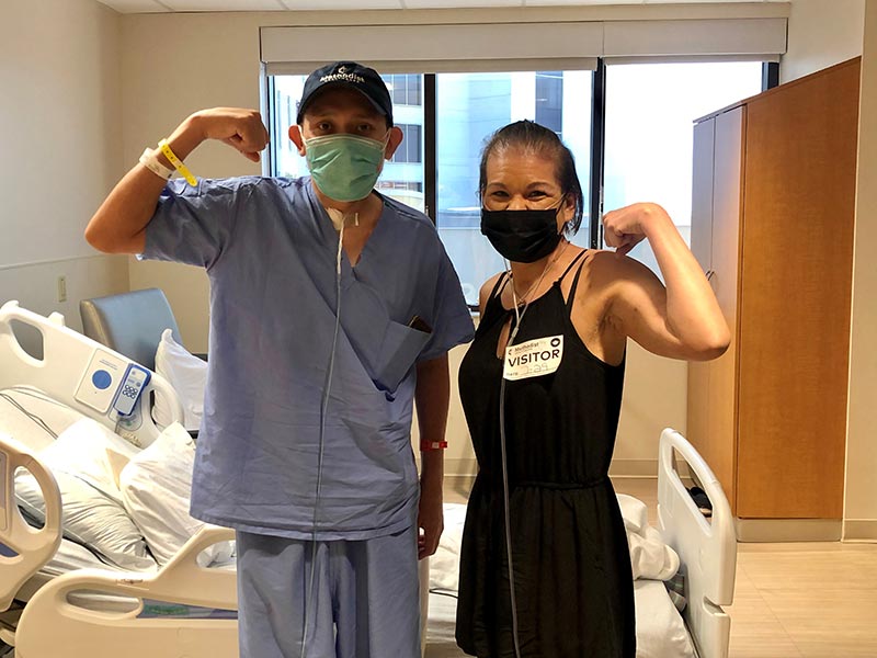 Carlos Gonzalez and Amy Velez flexing.