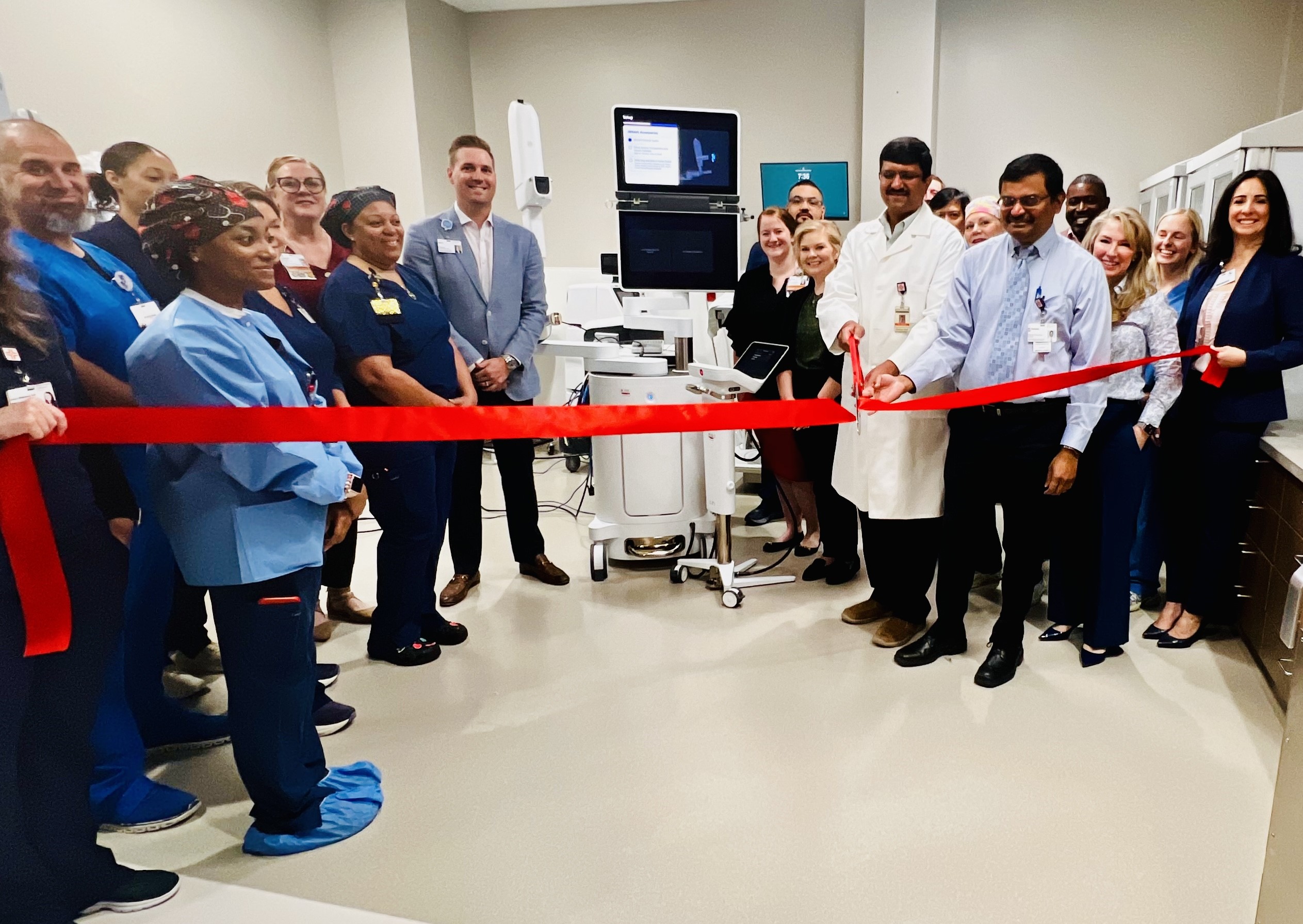 Kingwood bronchosopy team members cut a big red ribbon in hospital.