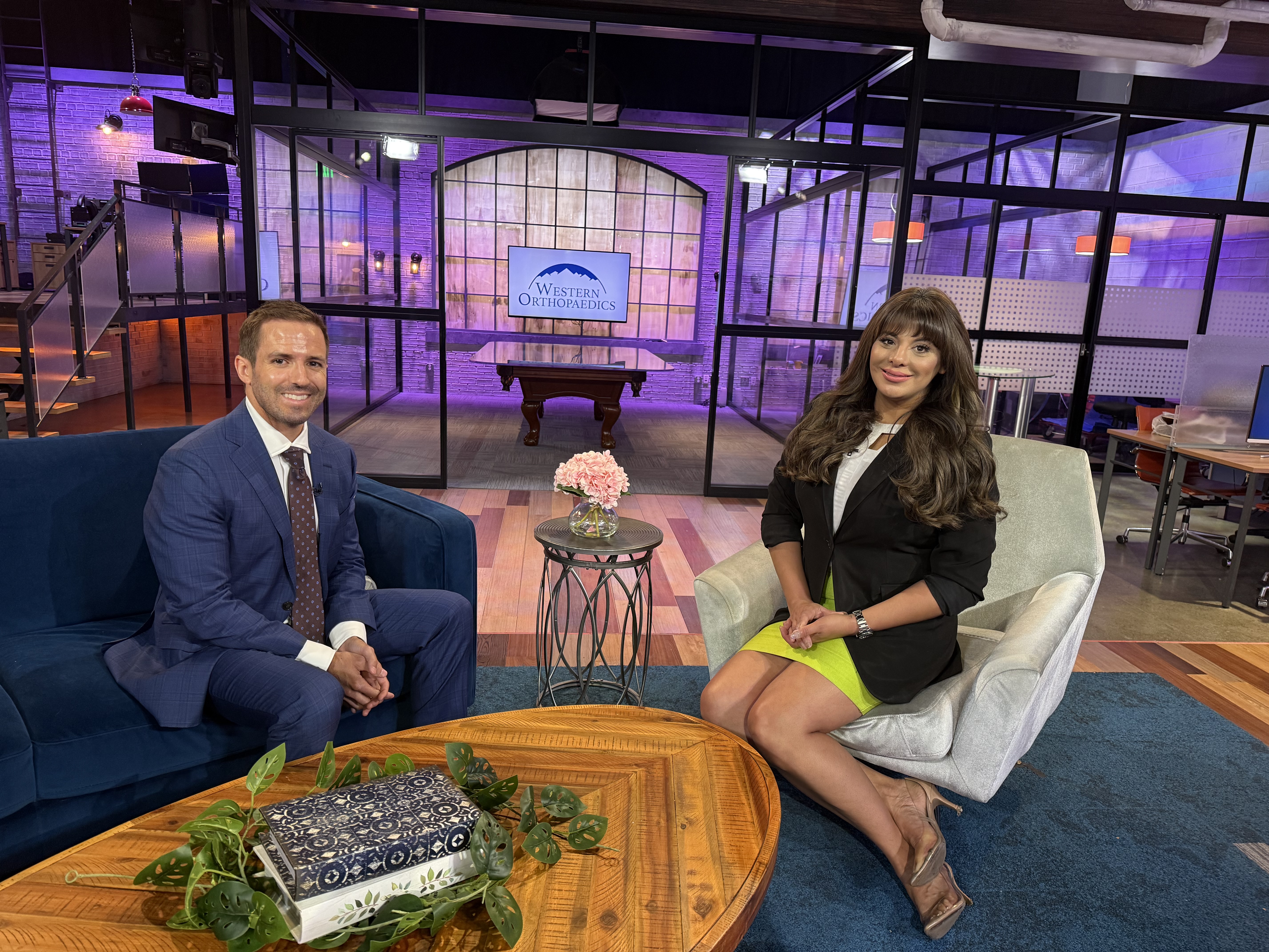 Dr. Baran sits with nes anchor on set of 9News Colorado.