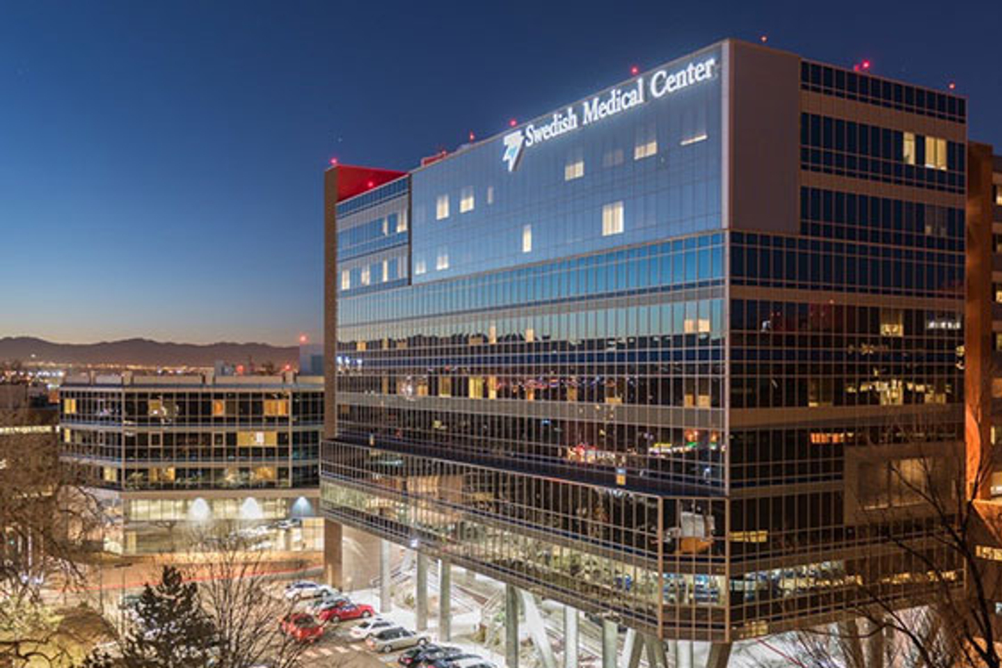 Exterior View of Swedish Medical Center as the sun setting reflects off the of building's windows