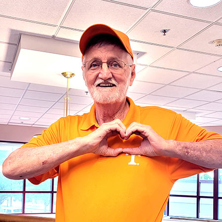  James “Jimmy” Howard smiling and forming a heart with his hands.