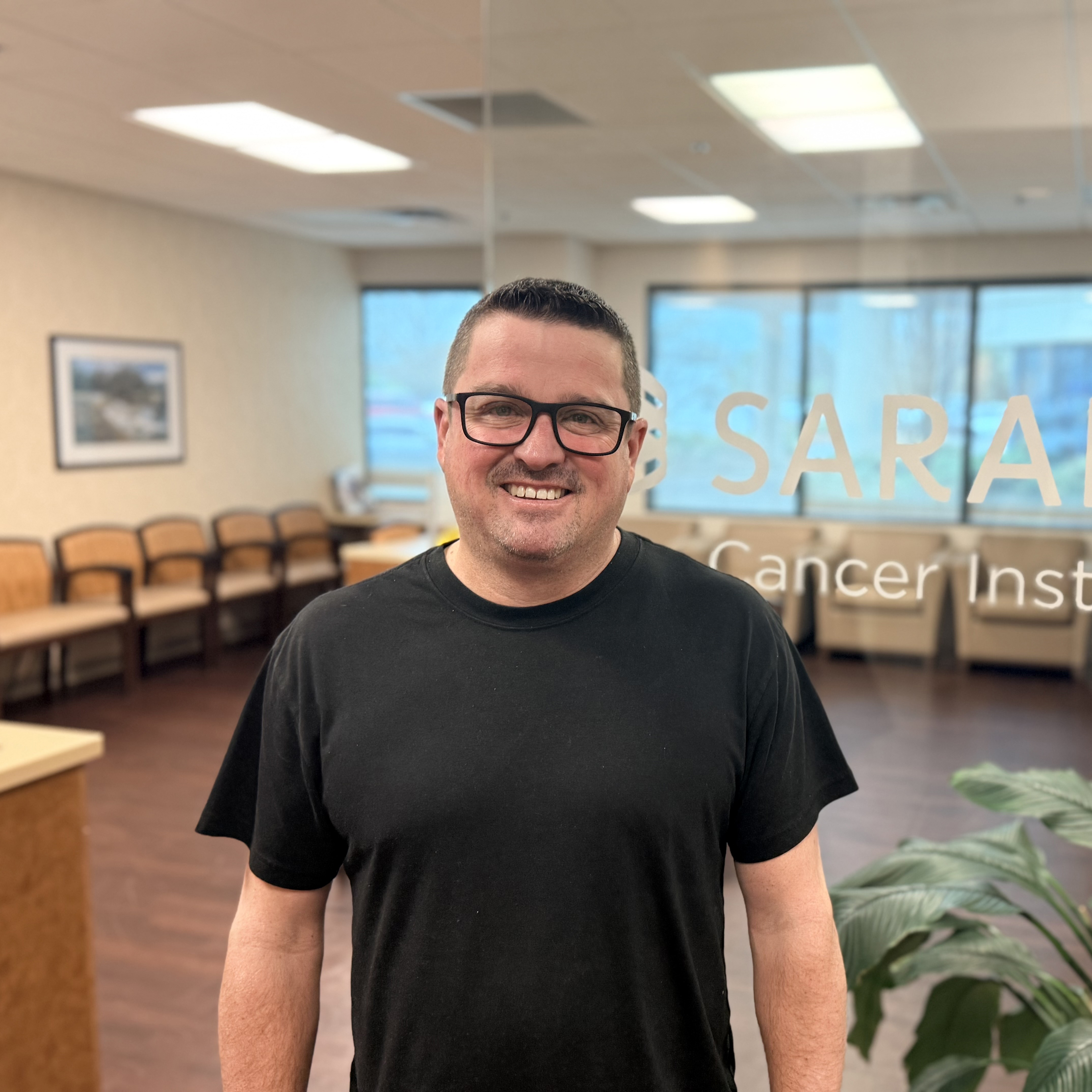 James “Jamey” Tidwell standing at Sarah Cannon