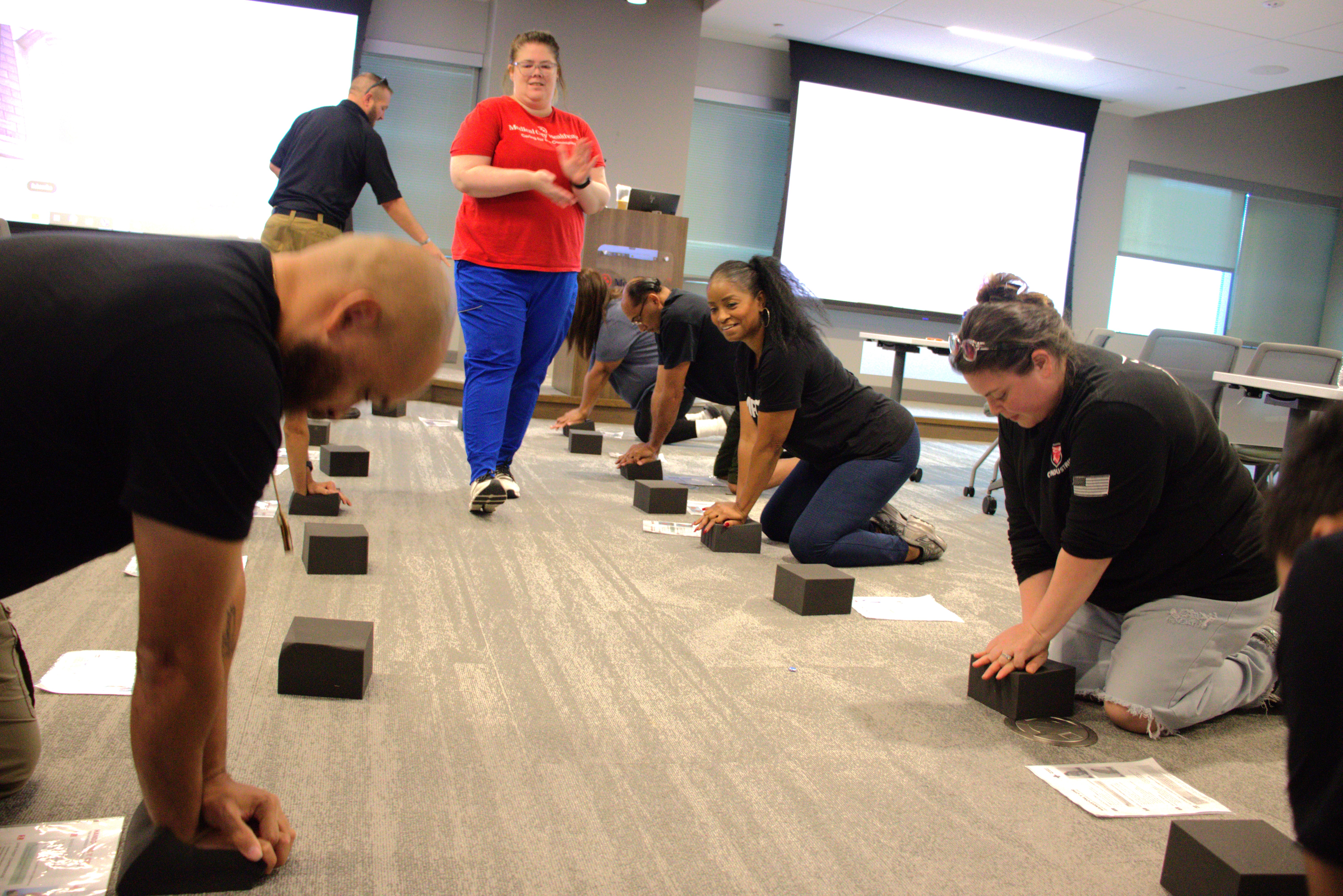 People practicing heart compressions.