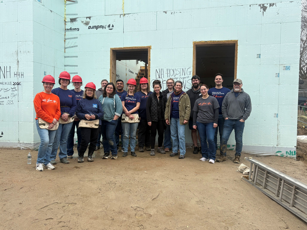 Colleagues pause for a photo during the 2026 Habitat for Humanity project.