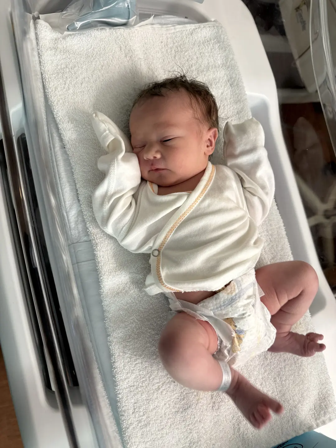 newborn baby KJ in a bassinet