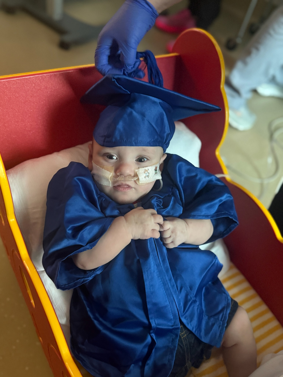 Baby John in graduation cap and gown