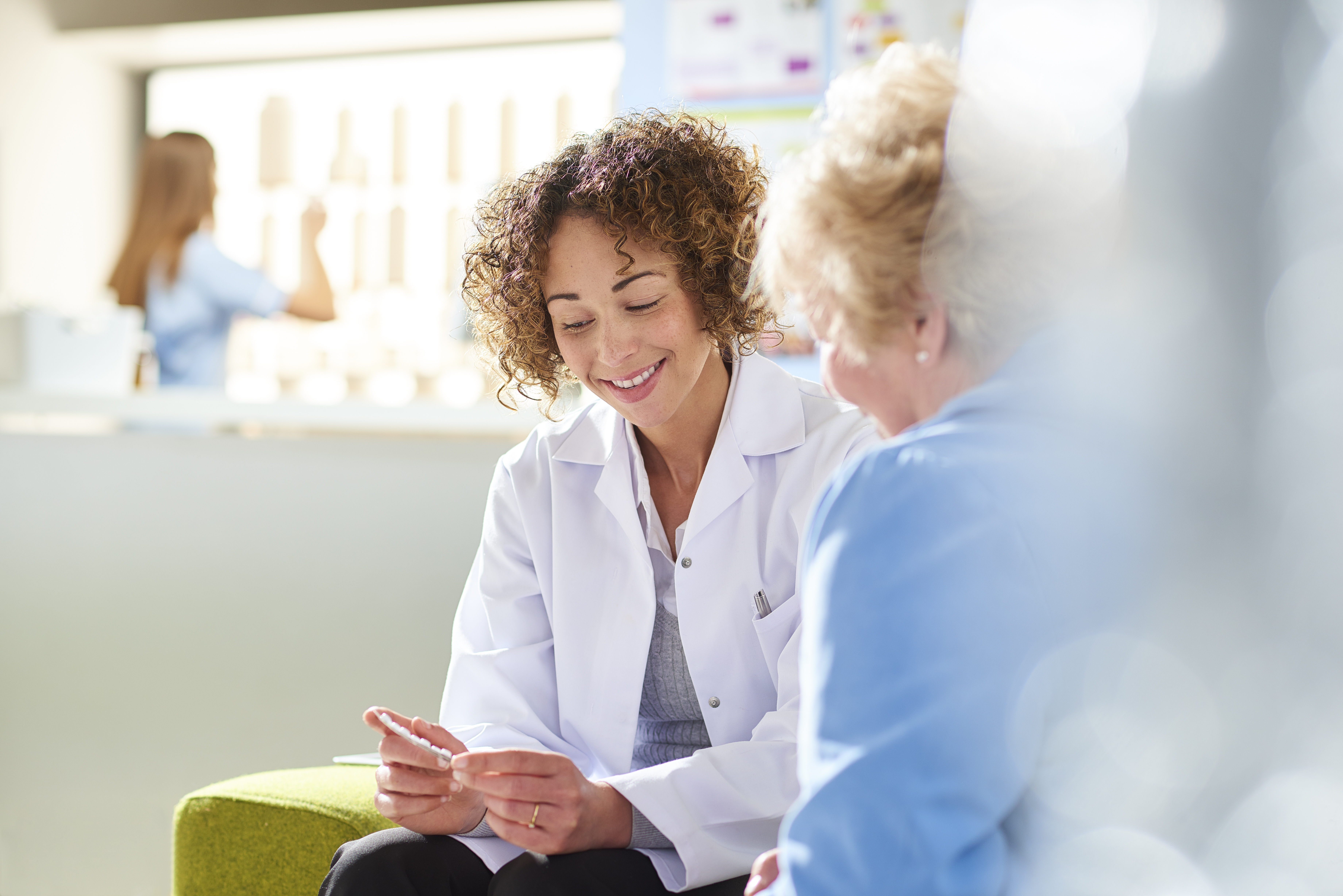 A physician talks with her patient.