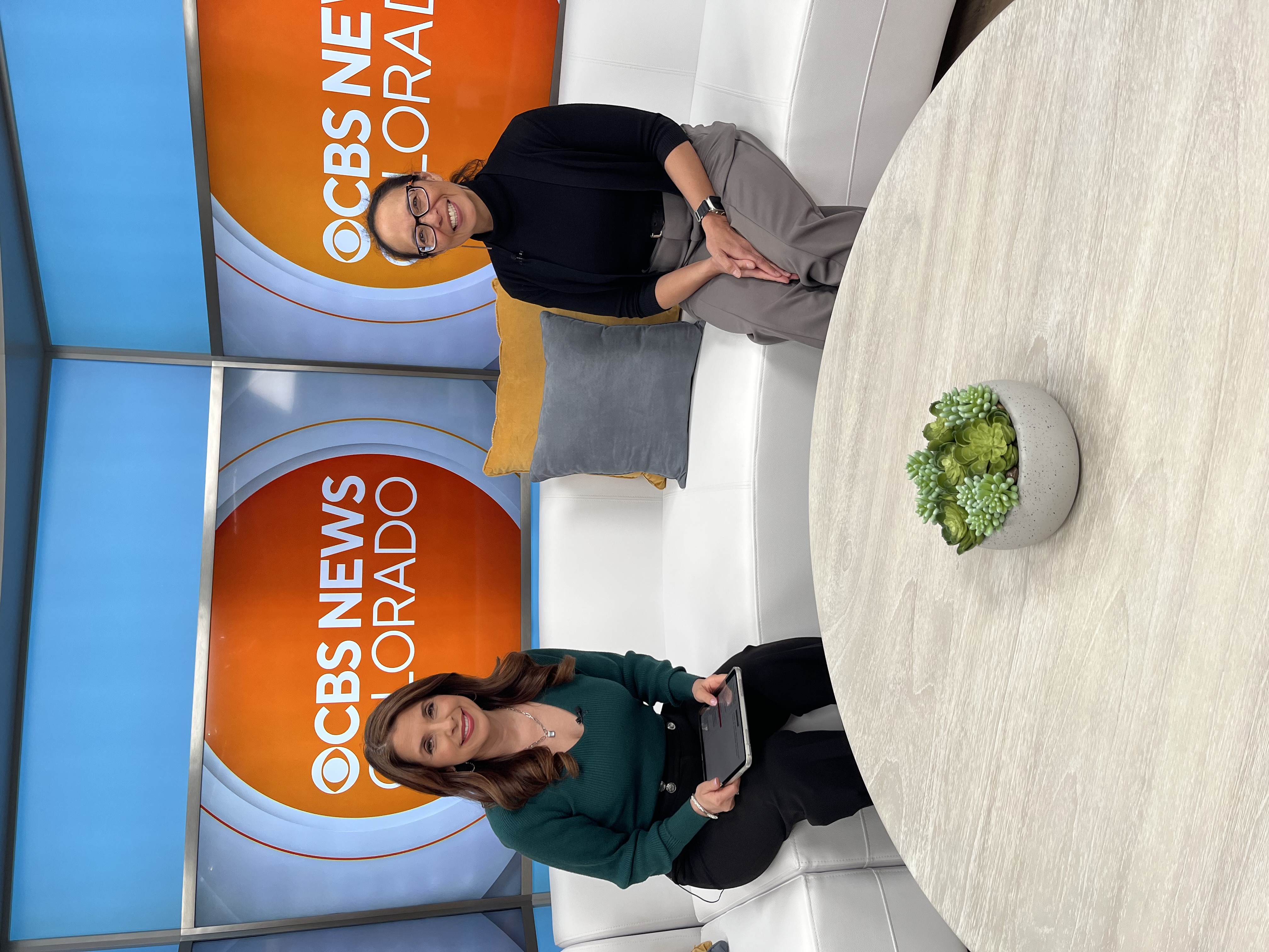 Dr. Mary Ann Huang and a newscaster from CBS on set for an interview.