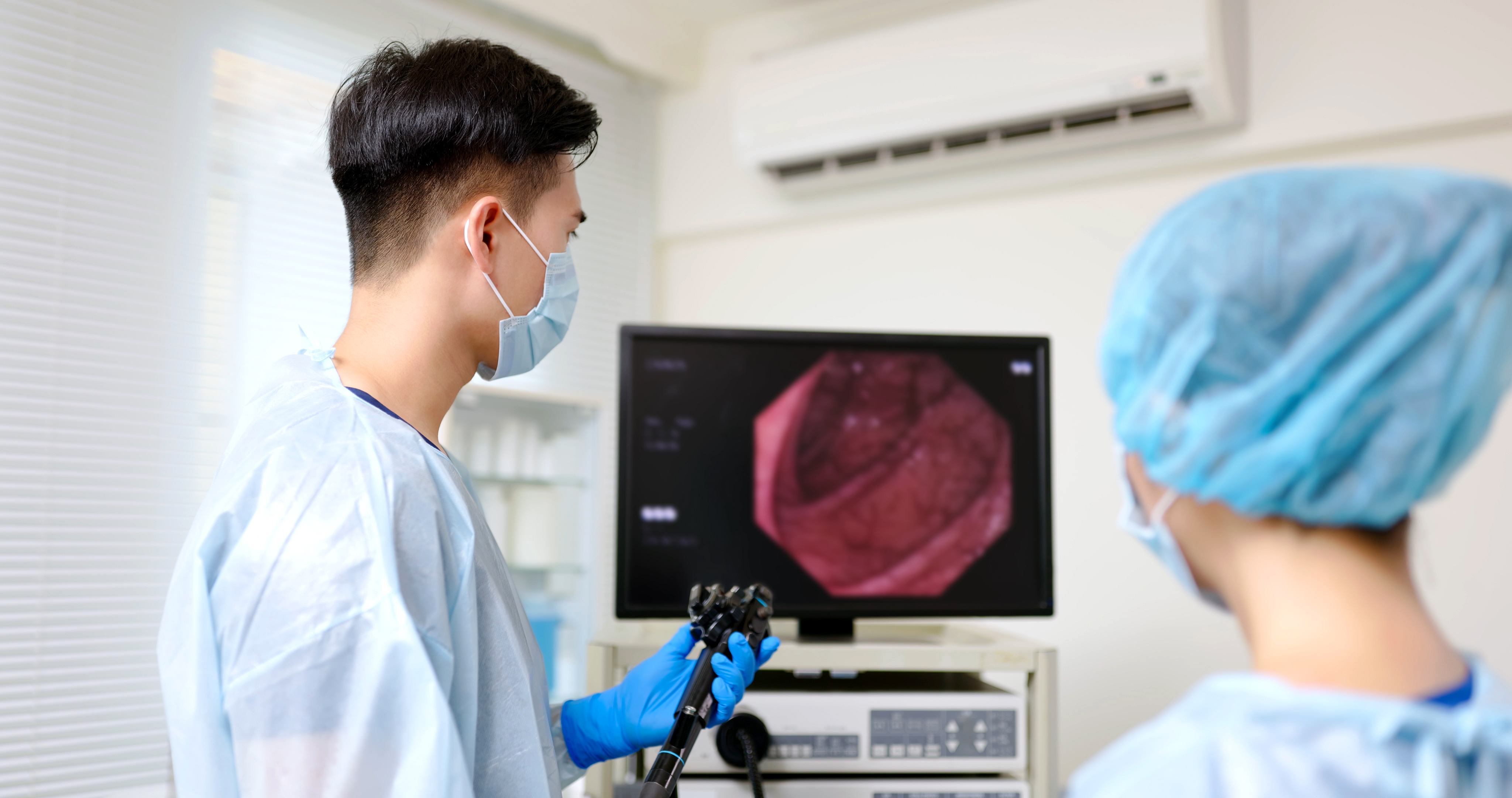  Surgeon and nurse looking at a monitor during a screening