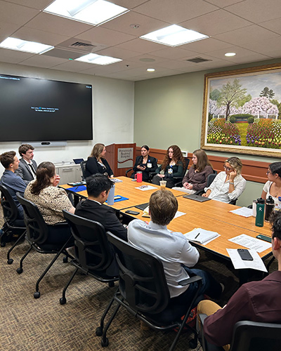 Volunteers are seated around a conference room table.