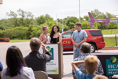 Shyann talks at a podium while reuniting with the emergency care team that helped her after a motor vehicle crash.