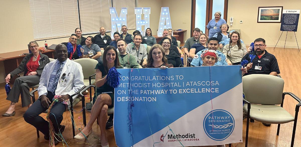 Atascosa staff posing with Pathway To Excellence banner.