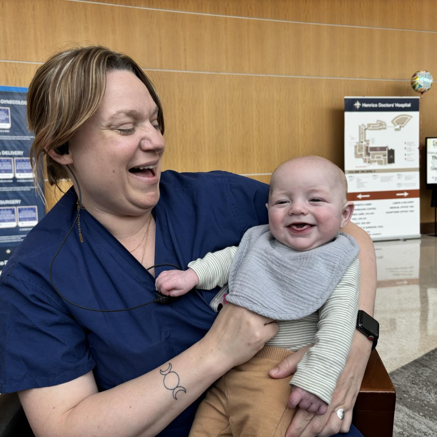 Emily Orange holding her smiling baby