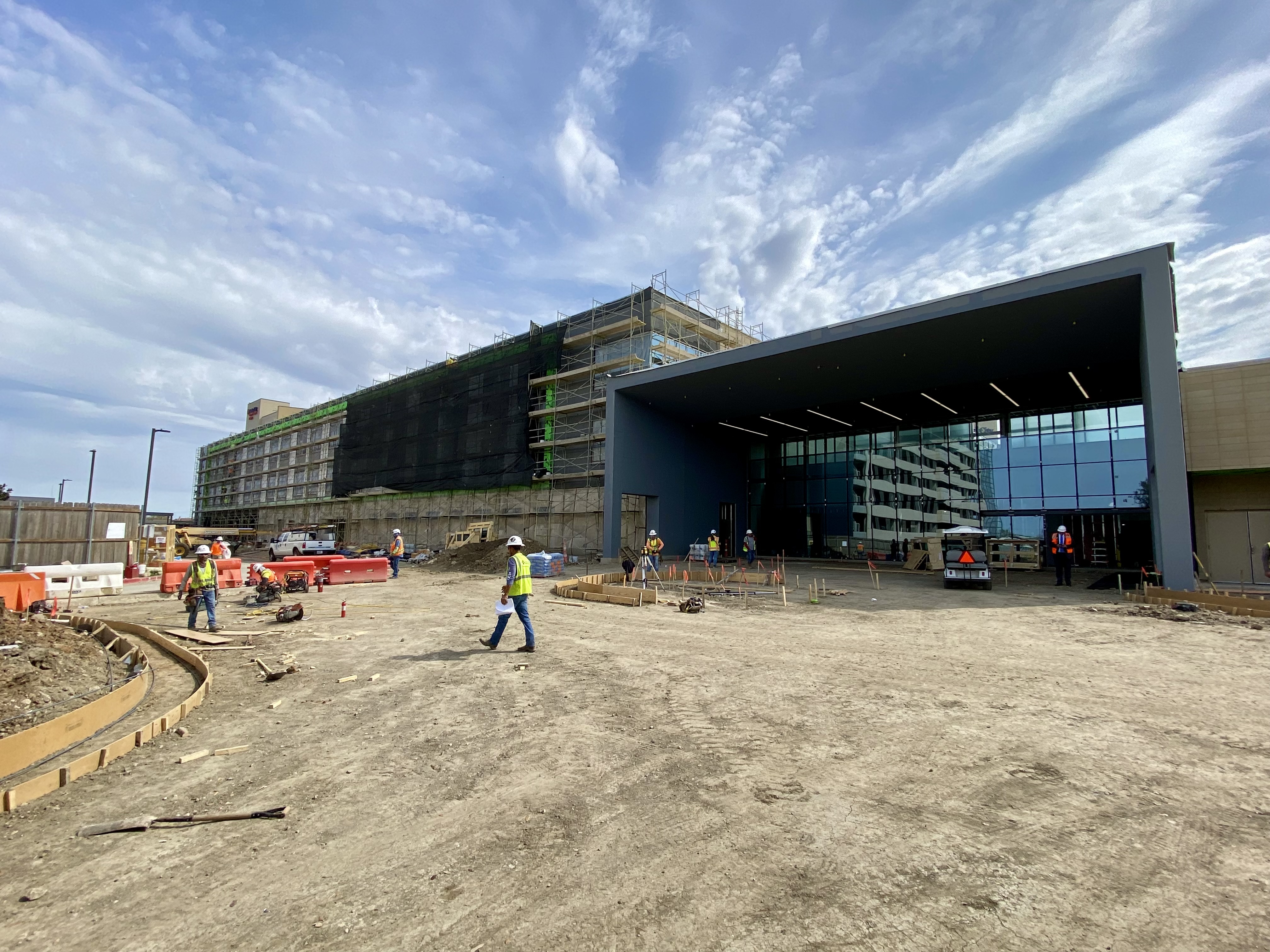 Medical City Arlington surgical expansion exterior under construction, about 70% done, construction workers and equipment surrounding it