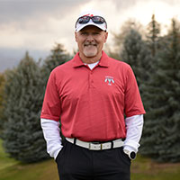 Steve smiles while taking a break during a game of golf.