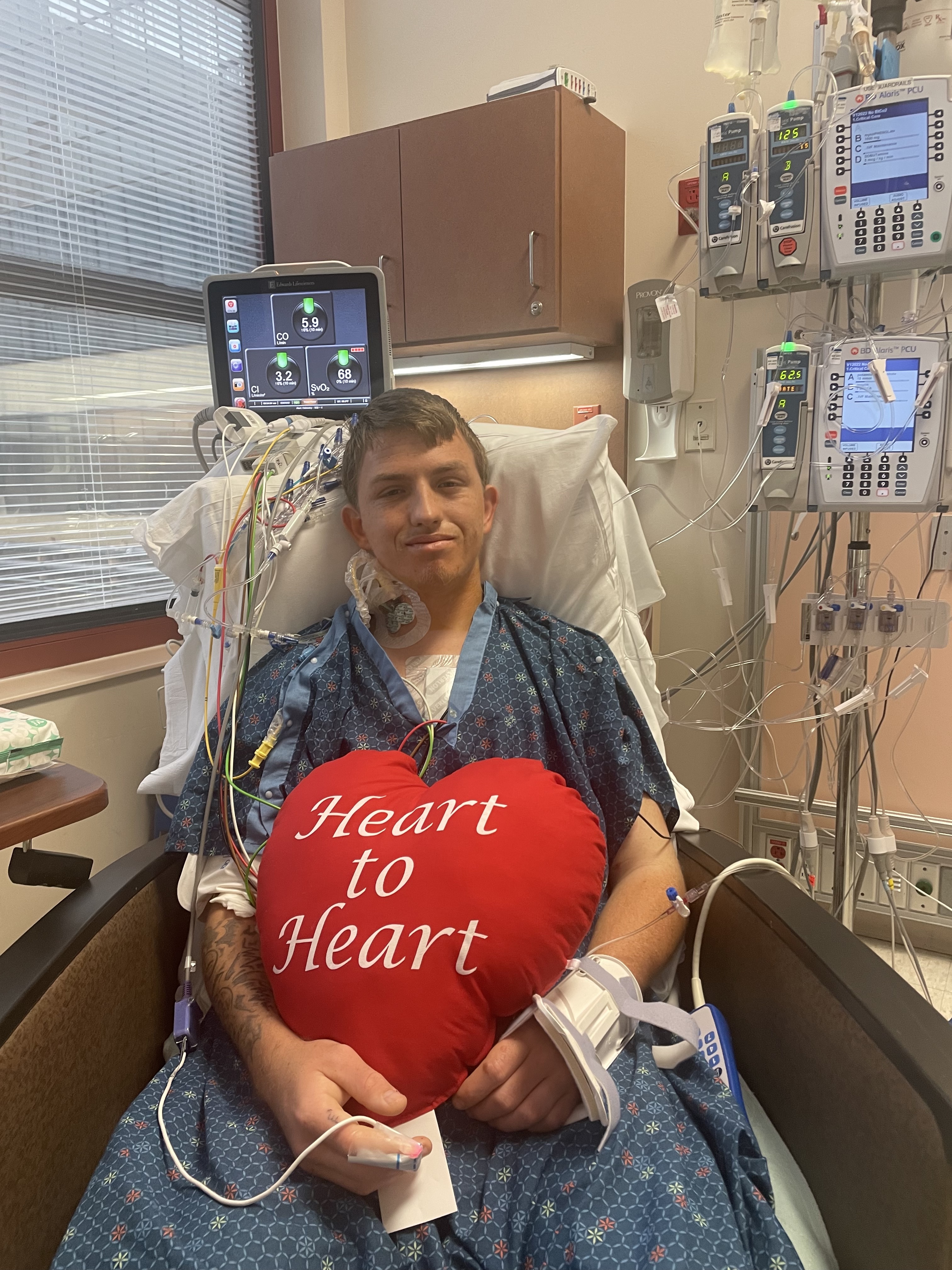 Danny Tucker holding heart pillow following his heart transplant procedure at HCA Florida Largo