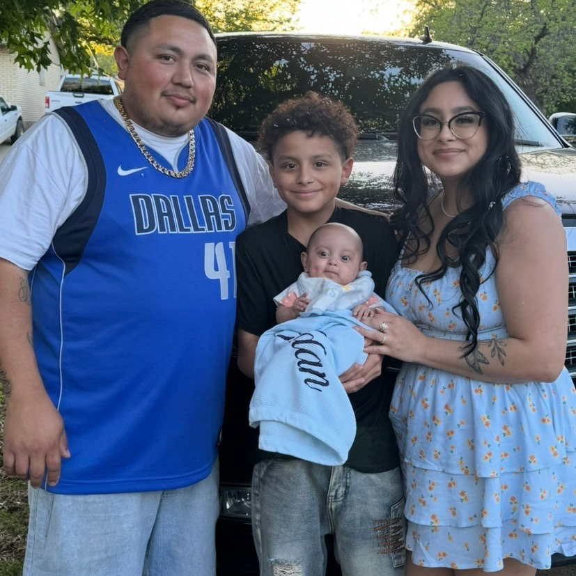 Baby Jordan and family back at home posing for photo in the front yard.