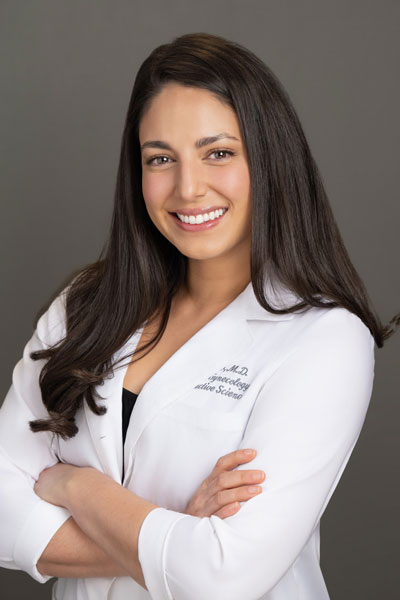 Headshot of pediatrician Dr. Ali Nazir. Dr. Nazir is wearing a white labcoat with black undershirt.