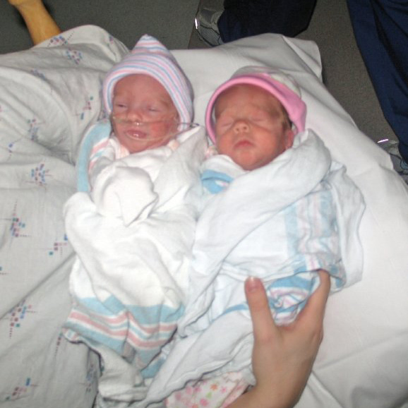 Newsborn Hannah and Kate  in crib.