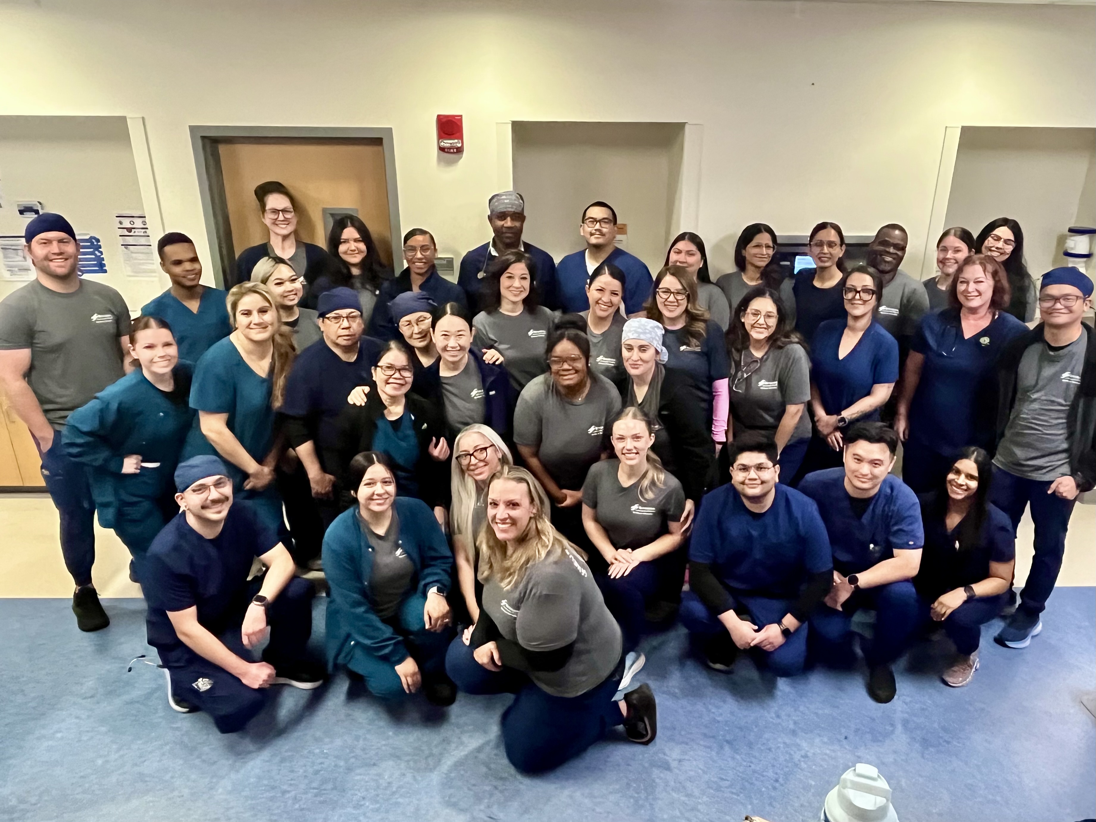 Group photo of Riverside Community Hospital care team members gathered inside a patient care area, smiling together to celebrate G6 Telemetry Neuro receiving a 2025 HCA Healthcare Unit of Distinction honorable mention in medical-surgical care.