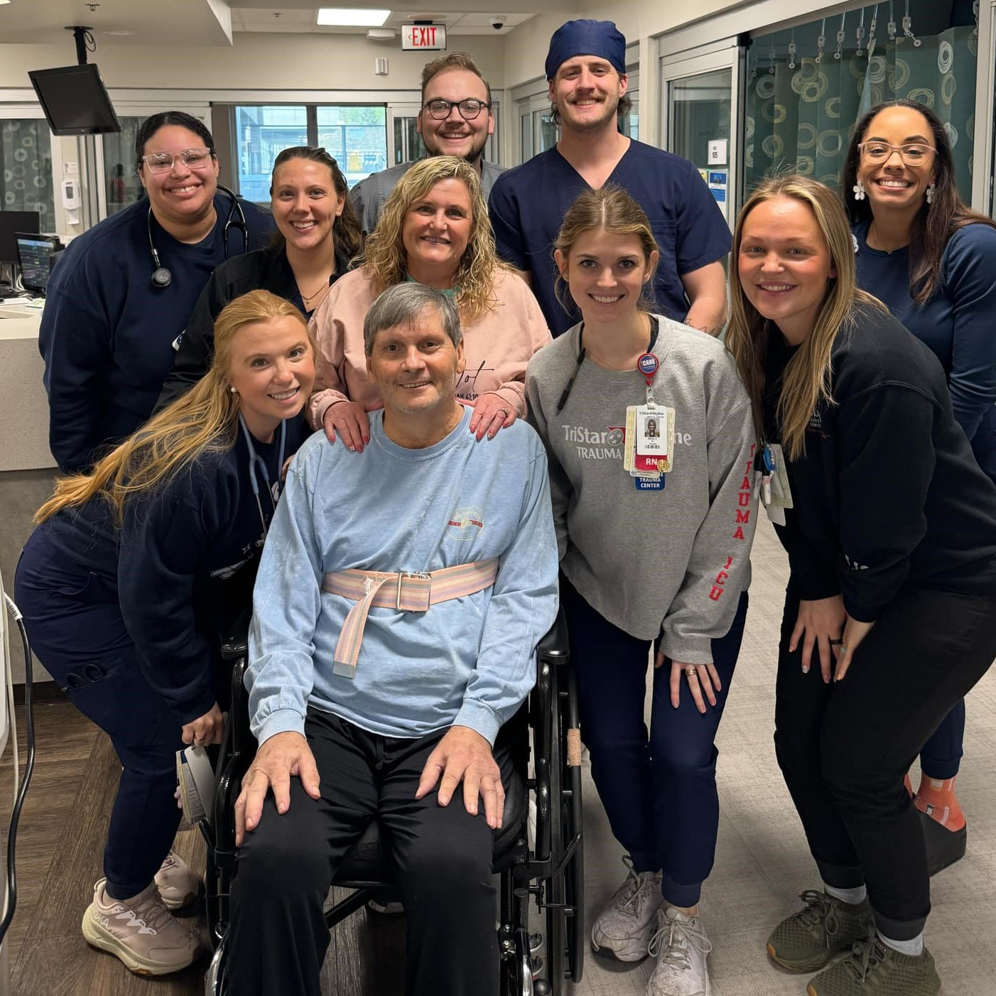 Trent Snead, in wheelchair, and wife, Renee, behind hiim, posing with Tristar staff in hospital.
