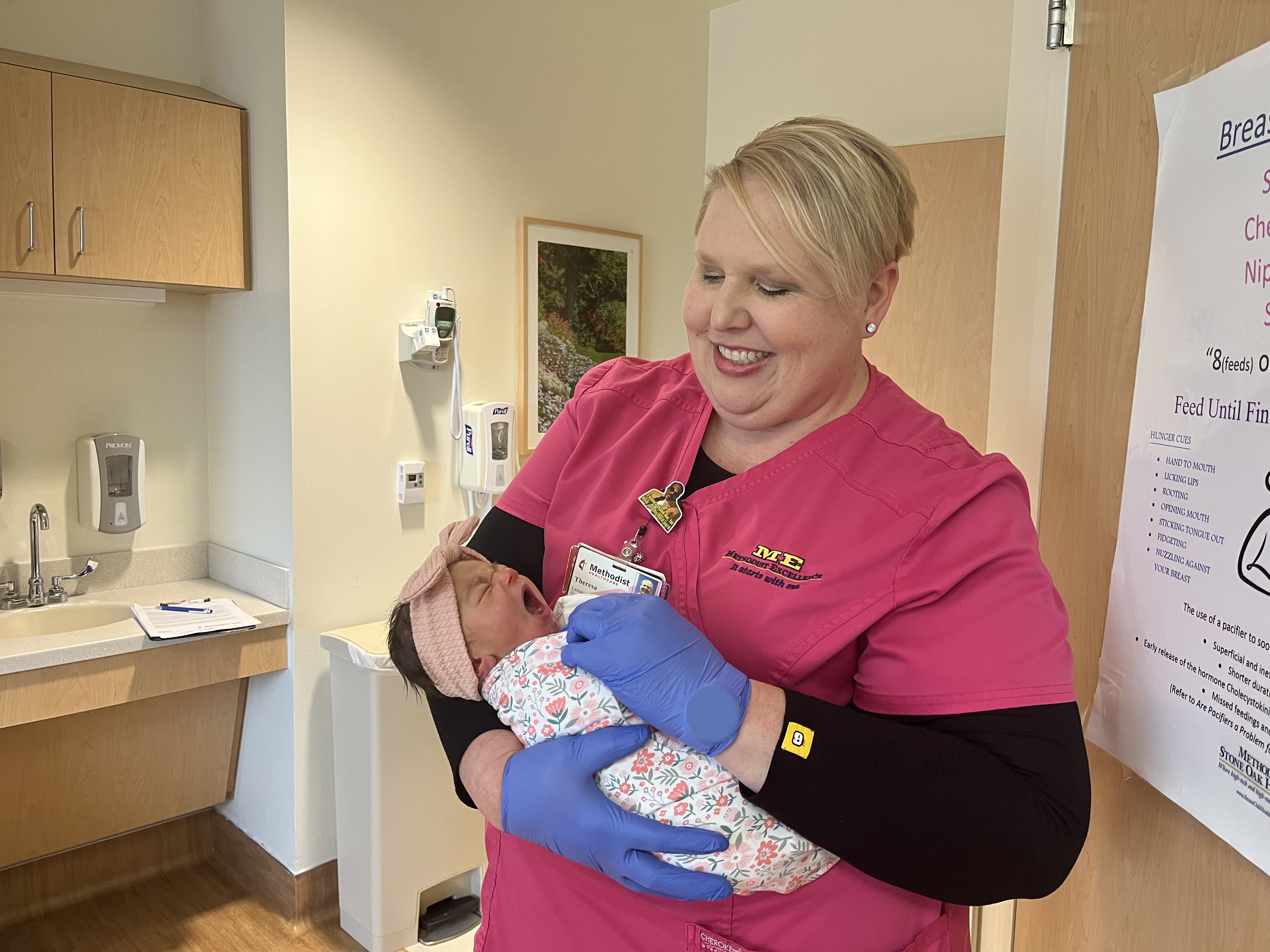 Lactation Consultant demonstrates how to properly feed baby. 