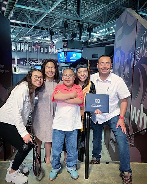 Linda and her family on the day she graduated with her associates degree.