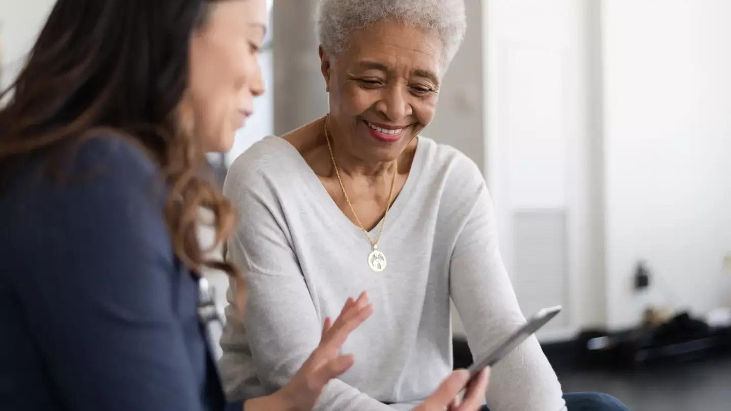 A smiling mature woman consulted with a female doctor