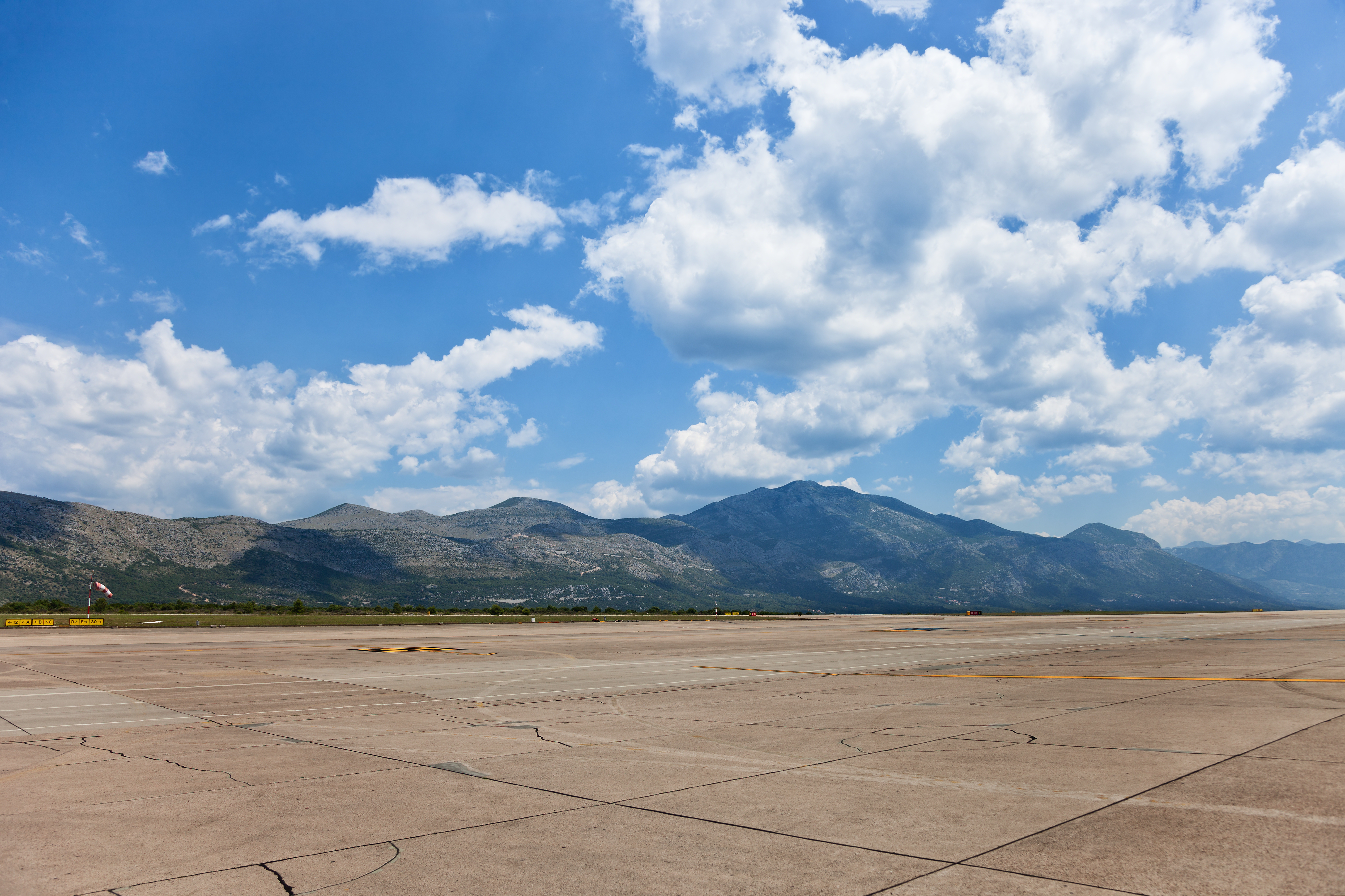 Airport Dubrovnik stock photo of empty air field runway and mountain range against blue sky