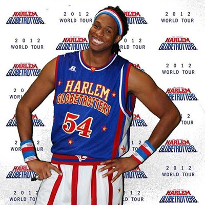 Former Harlem Globetrotter Jay 'Stretch' Middleton, smiling, in his Globetrotter uniform.
