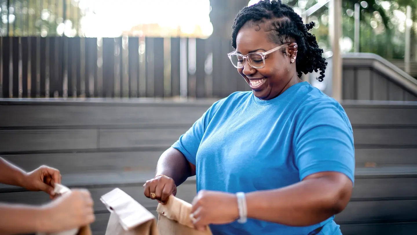 Person putting together bags of food for charity