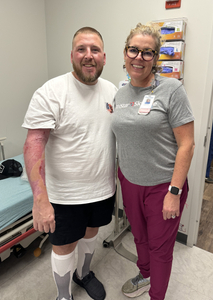 Jeremy Crowe posing with a TriStar nurse