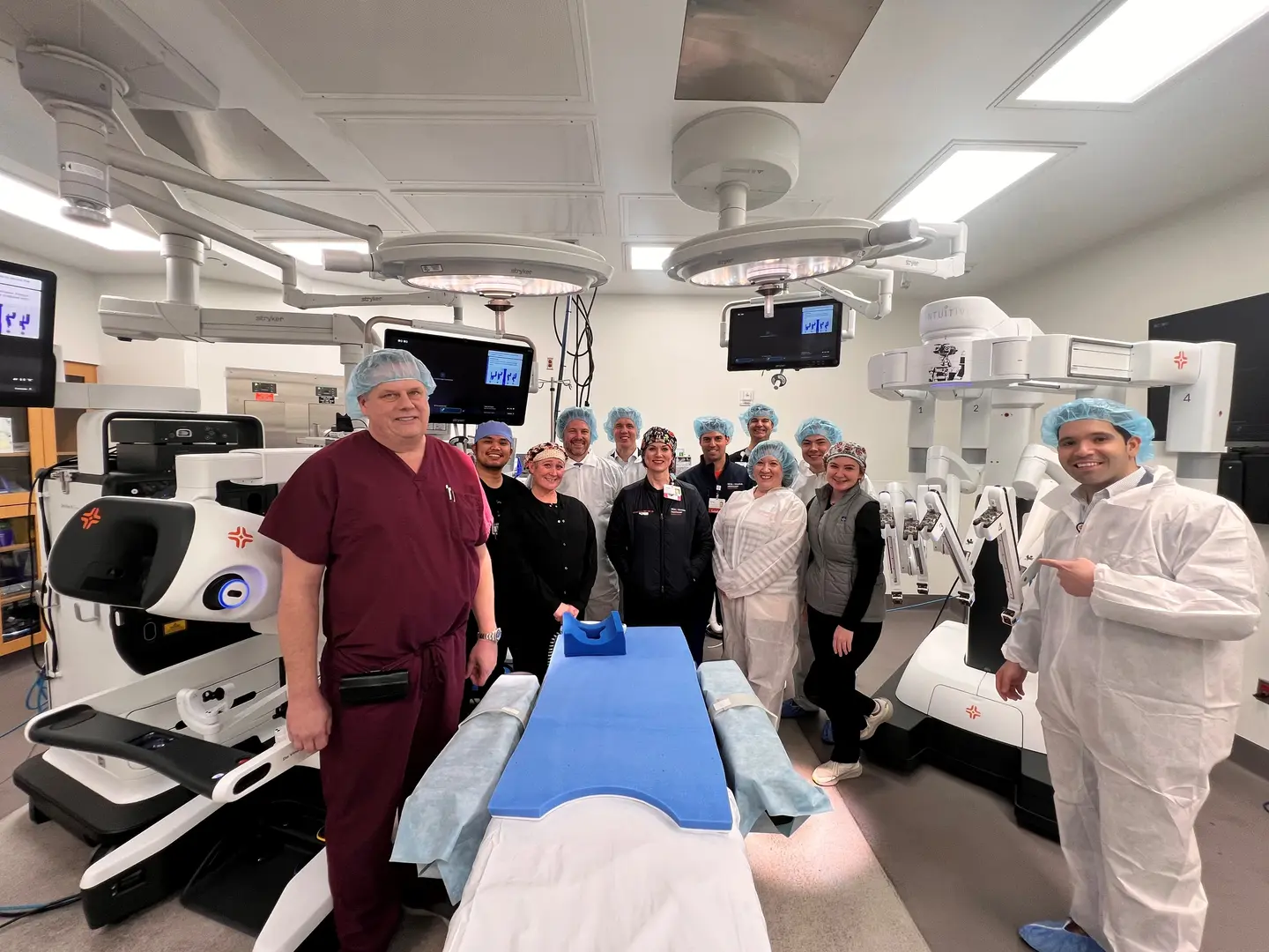Dr. Terry Scarborough, his surgical team and facility leaders with the new robotic system.