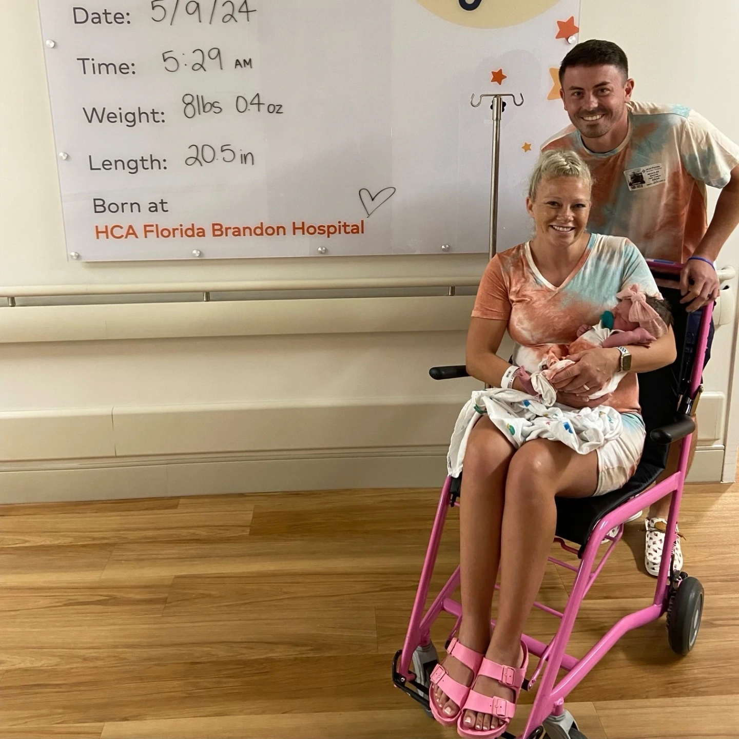 Nic posing with Jessica and newborn Indie leaving the hospital.
