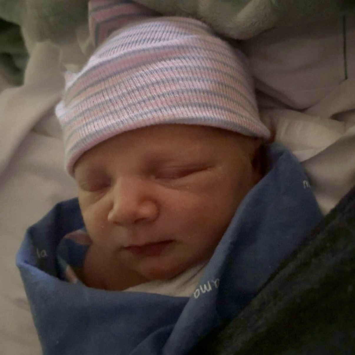 Baby Jaxon in newborn beanie.