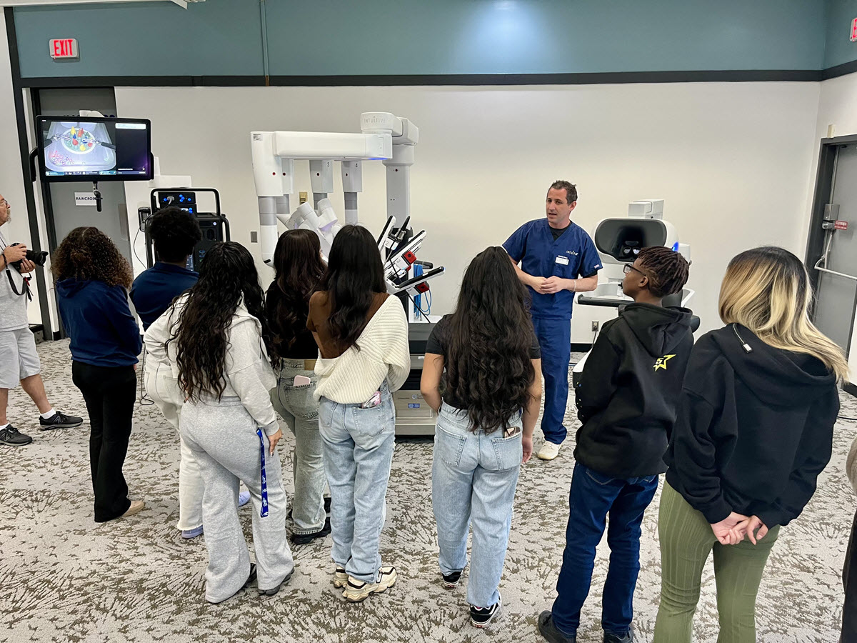 The students learn about one of our surgical robots.