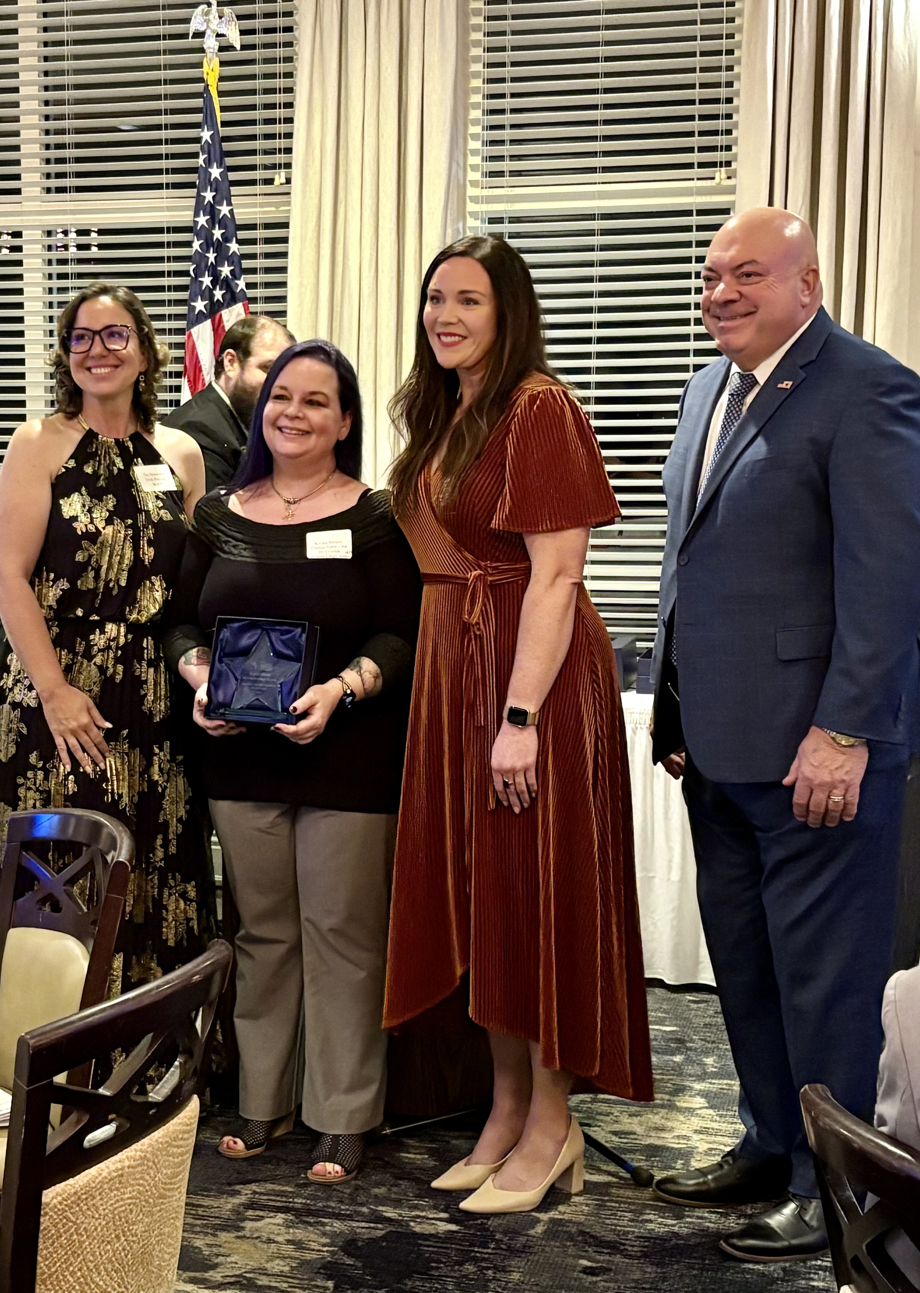 Krystal Minton accepting award with Paige Laughlin, CEO and Commissioners Petrosky and Pendergrass.