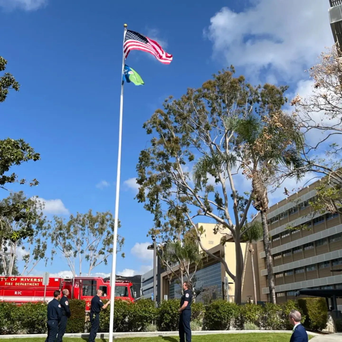 First responders raise the American and Donate Life flags on the flagpole before the Donate Life ceremony.