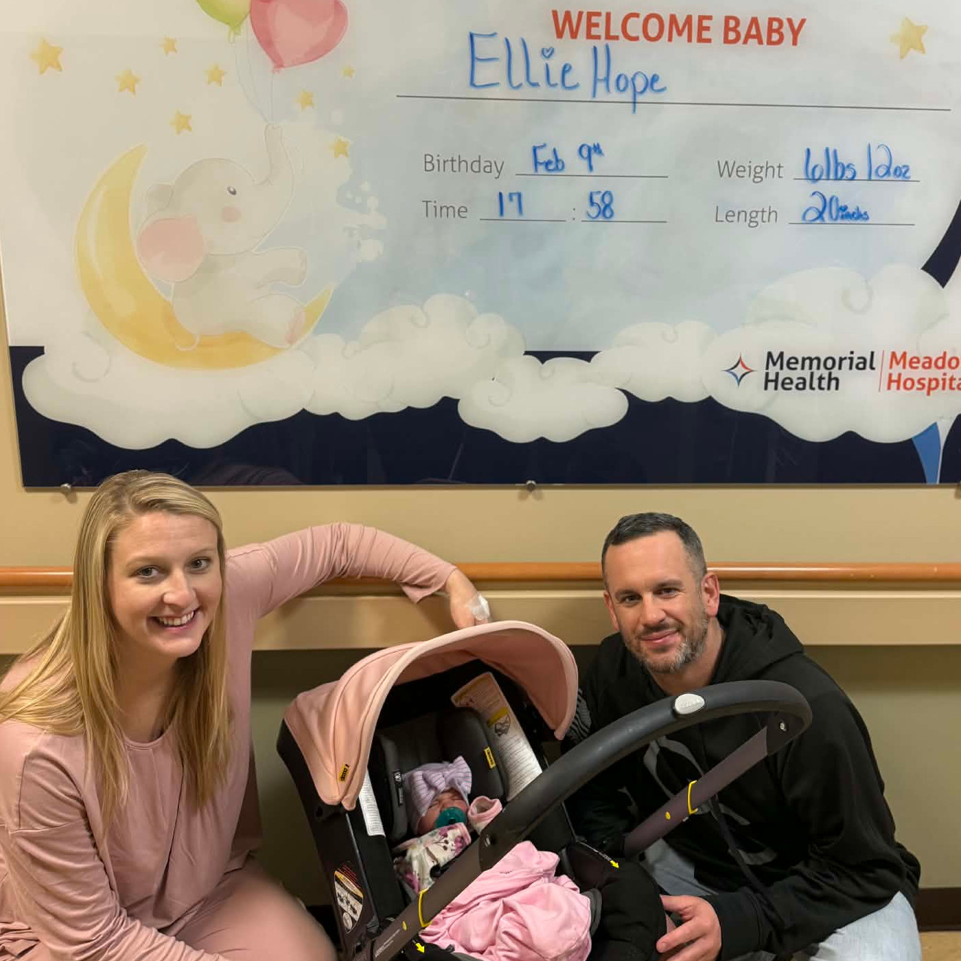 Danielle, her husband Michael and their baby girl Ellie Hope in her car seat.