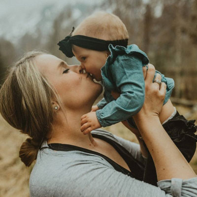 Laura Haitz lifting up her baby Ellie and giving her a kiss.