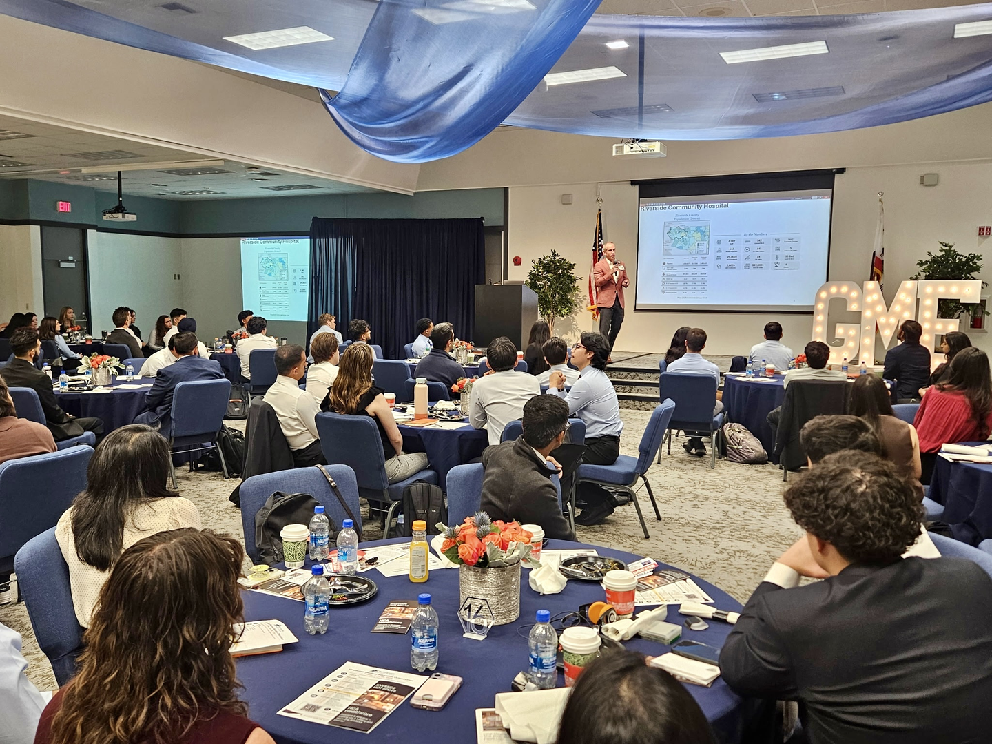 A group of new fellows and residents being welcomed by the CEO of Riverside Community Hospital Peter Hemstead.