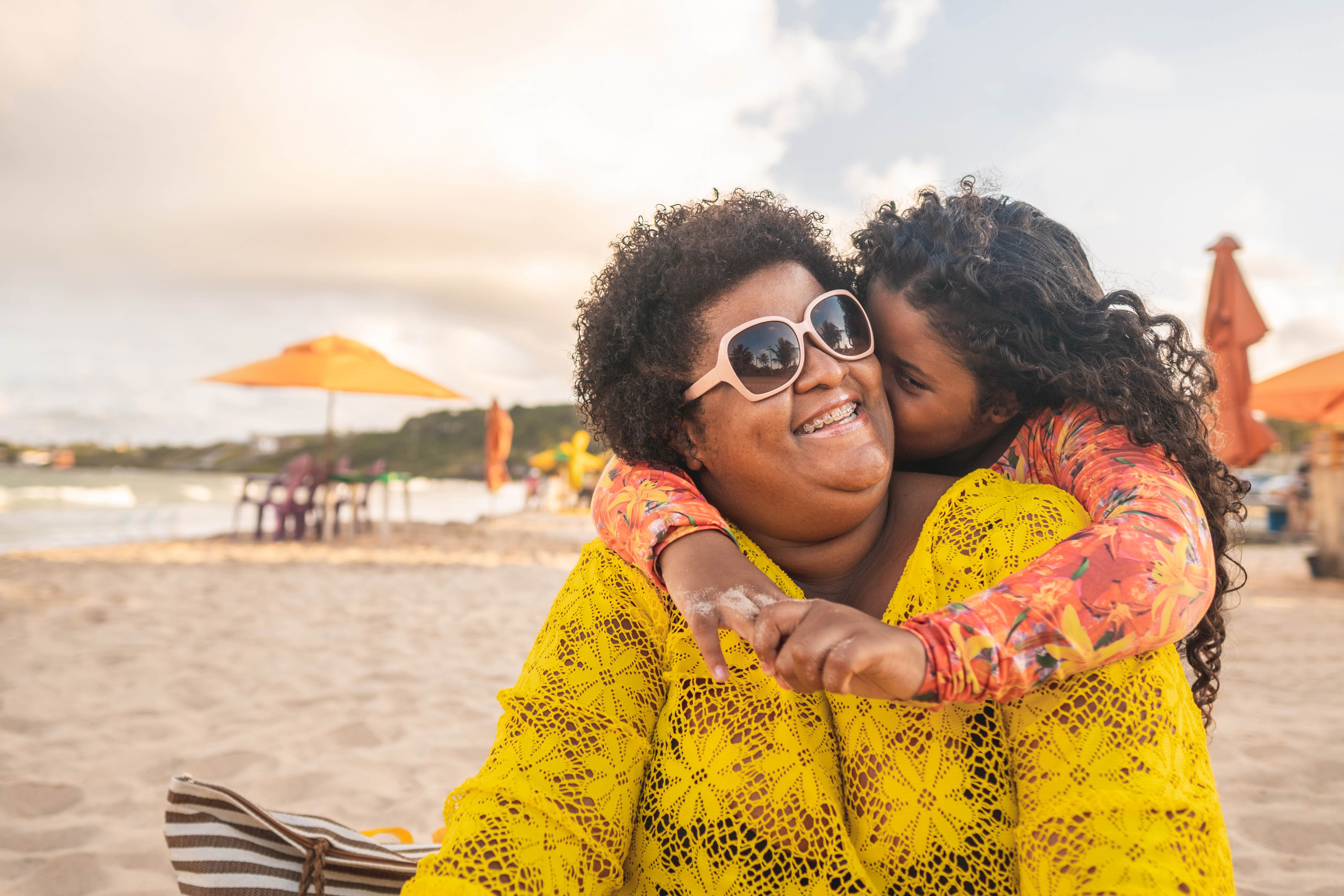 Mother and daughter hugging on the beach