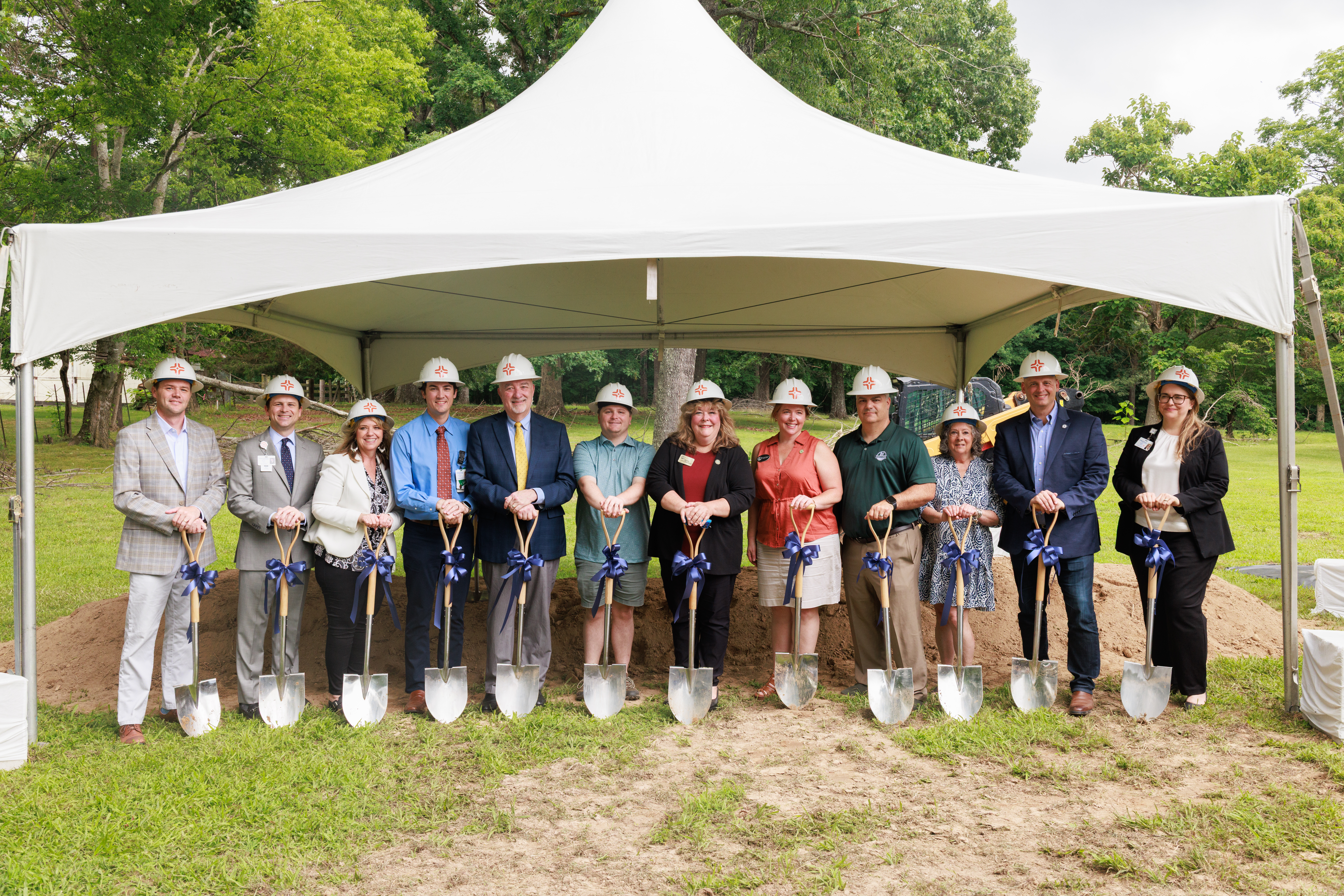 TriStar Horizon and City of Fairview leaders posing with shovels in front of equipment and a load of dirt on the site of the new ER.