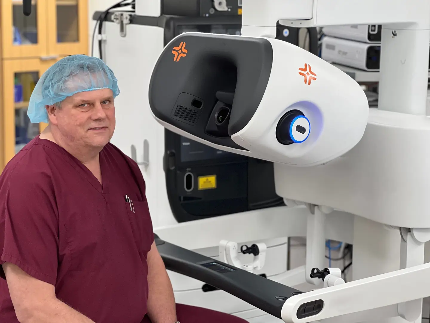 Dr. Terry Scarborough sitting at a new surgical robot