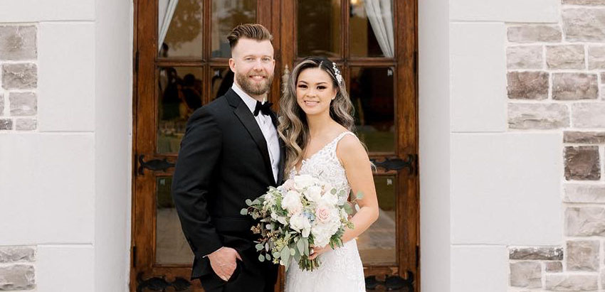 Kyle and Quyen smile for their wedding picture.
