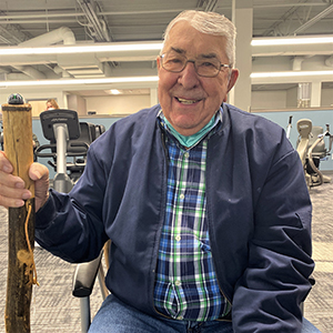 Max Tolman sitting in the cardiac rehabilitation gym.