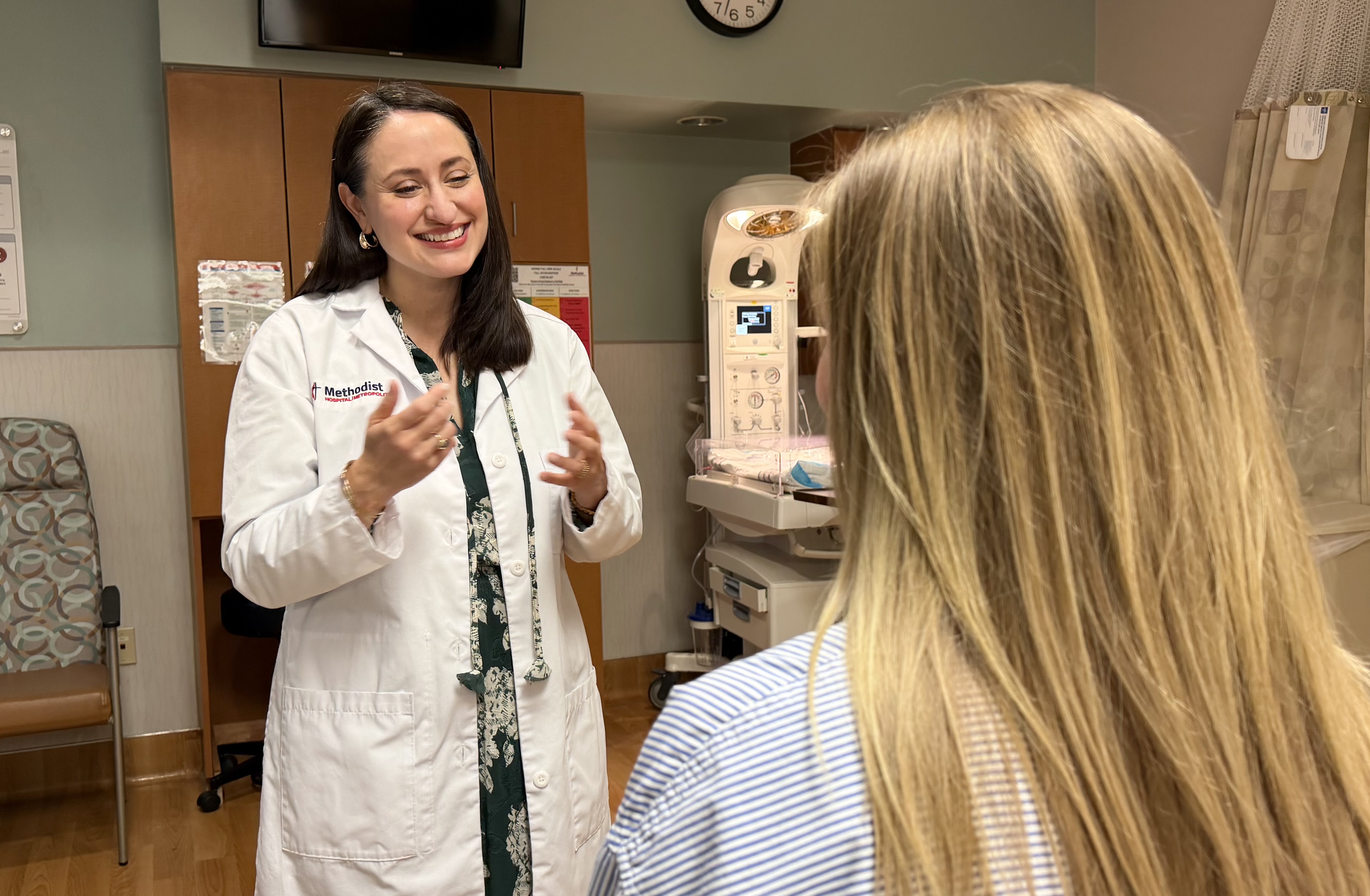 Dr. Nichole Van De Putte speaks to a patient on obstetrics care.